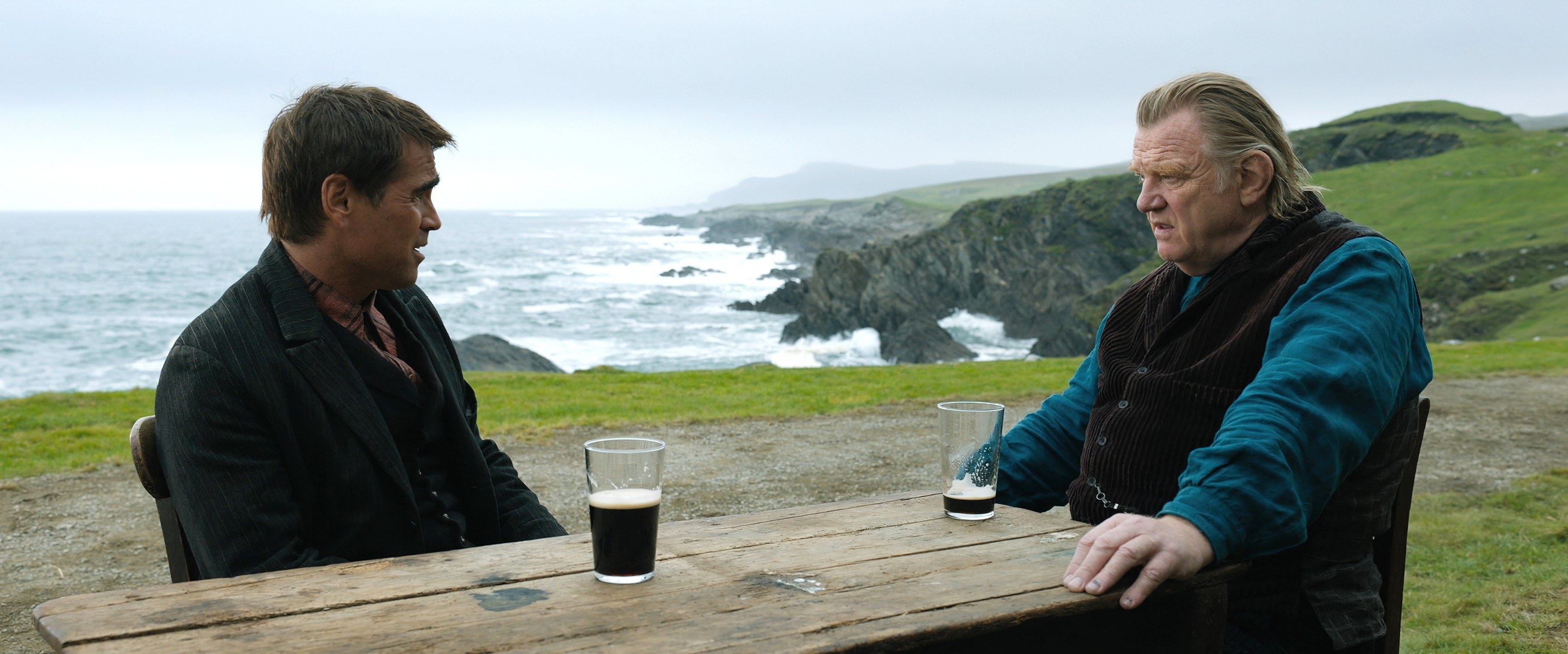 Colin Farrell and Brendan Gleeson drink beer by the ocean