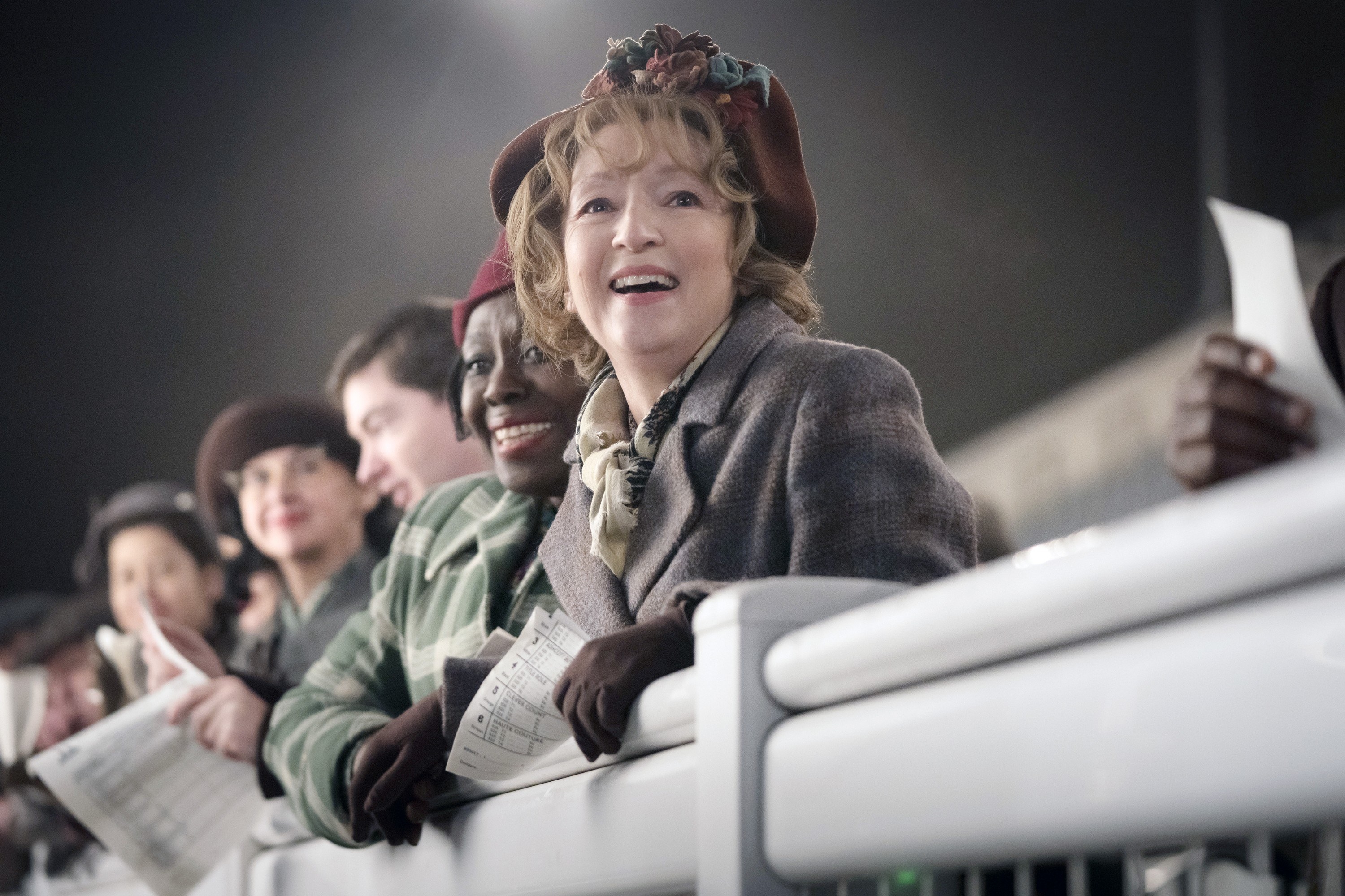 Lesley Manville smiles over a railing