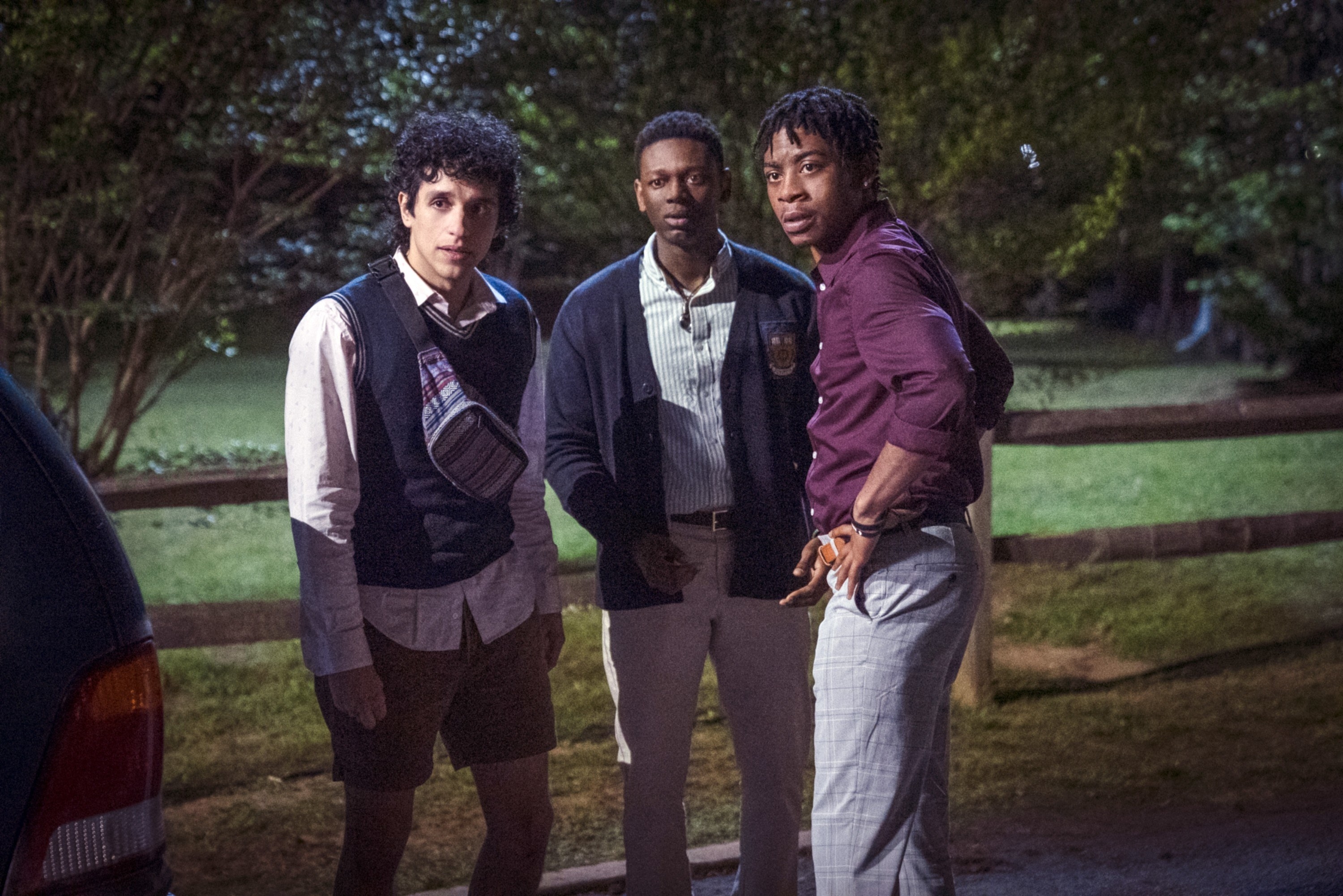 Sebastian Chacon, Donald Elise Watkins, and RJ Cyler stand by the side of the road