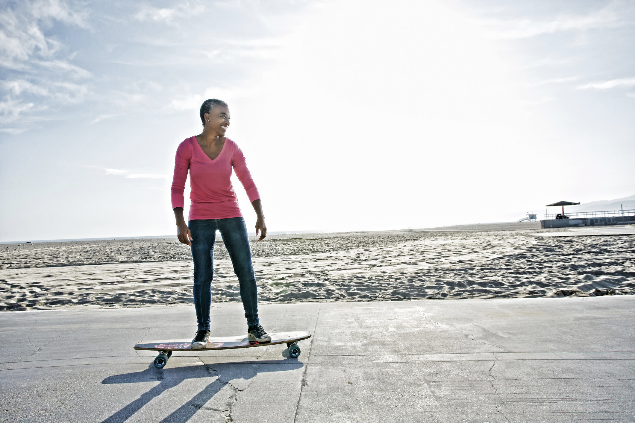 Smiling woman on a skateboard