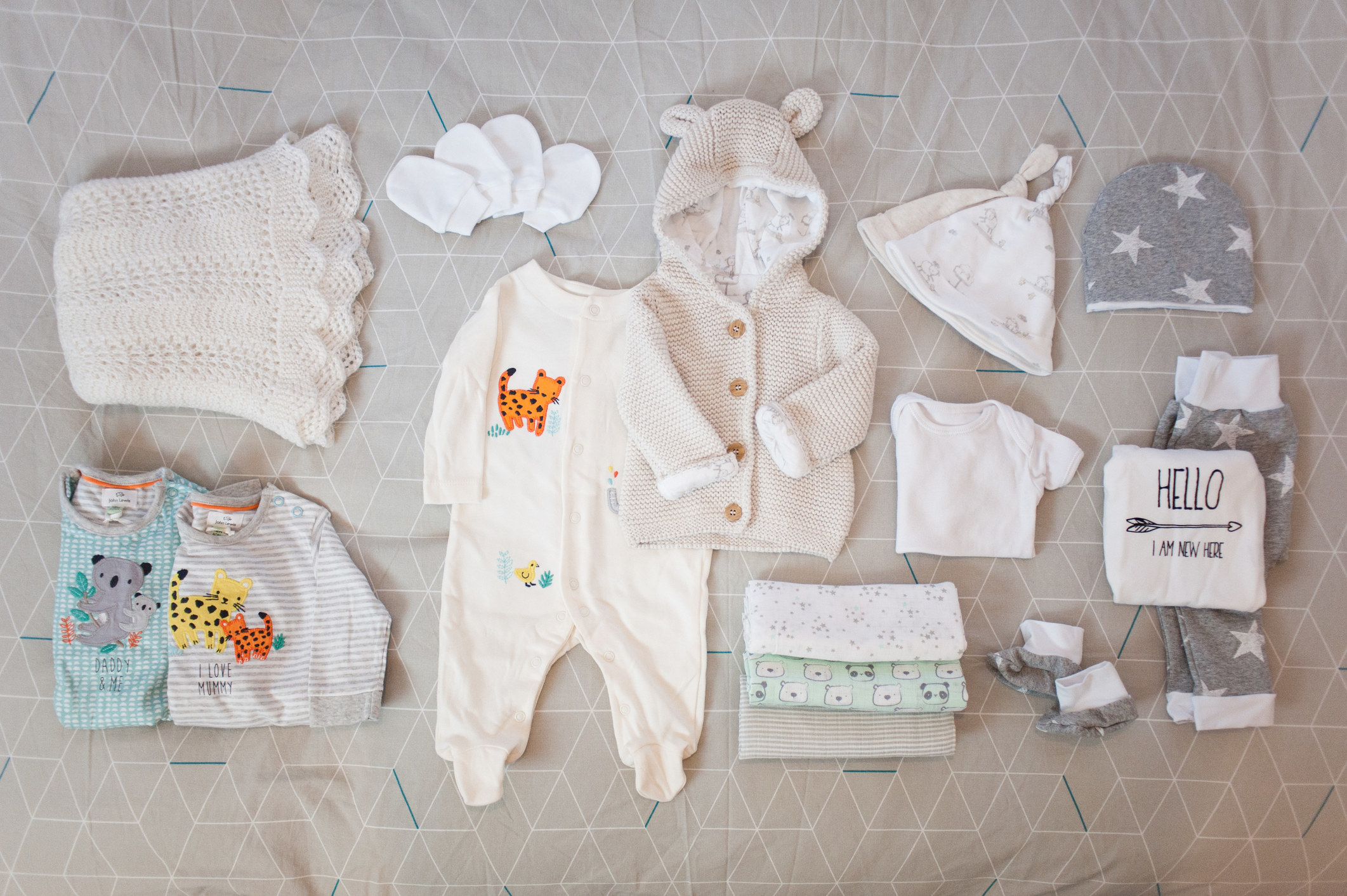 Image of baby clothes and hats and blankets