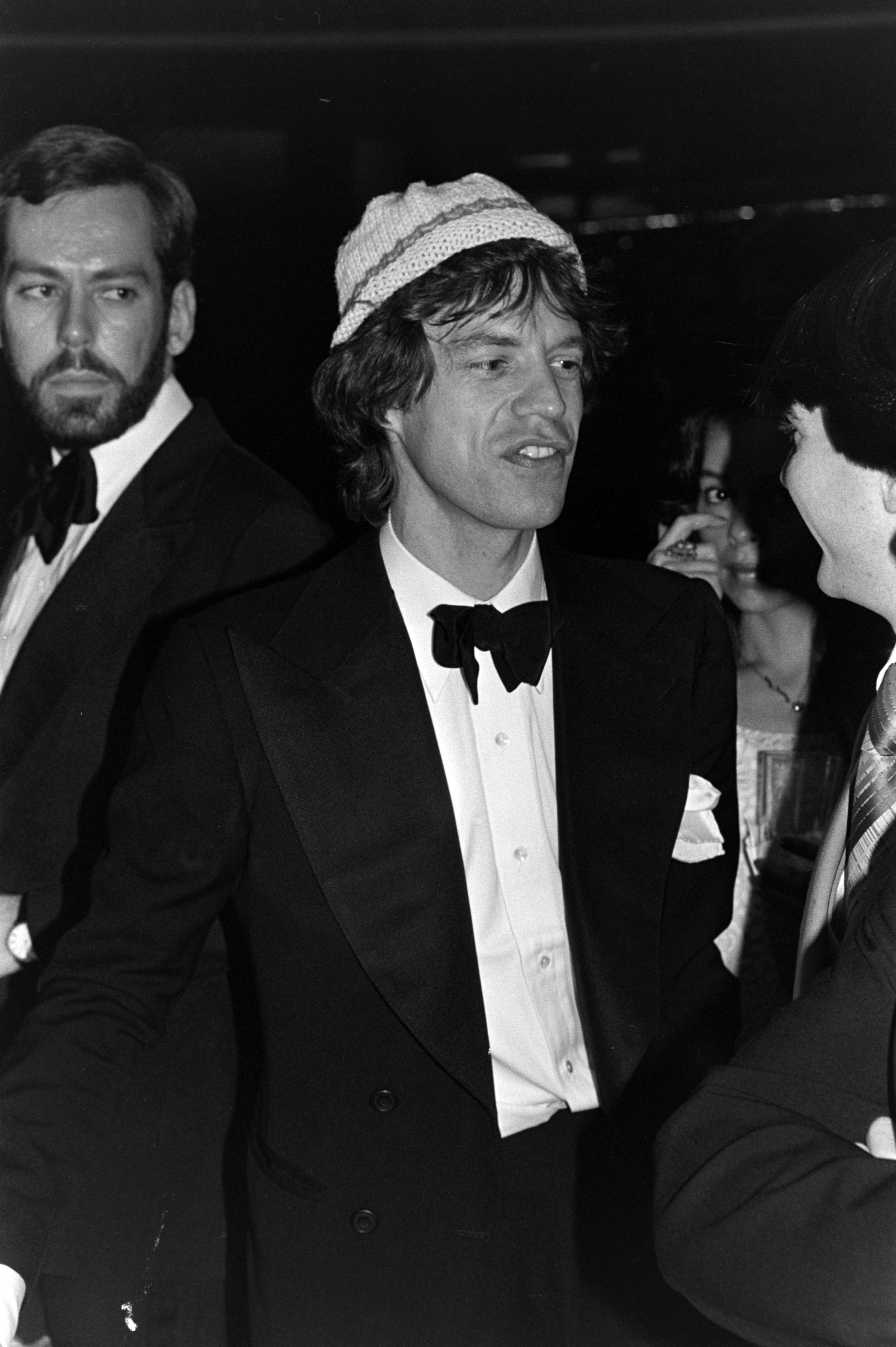 Mick with a bow tie and wearing a hat