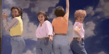 Four women dancing in &quot;mom jeans.&quot;
