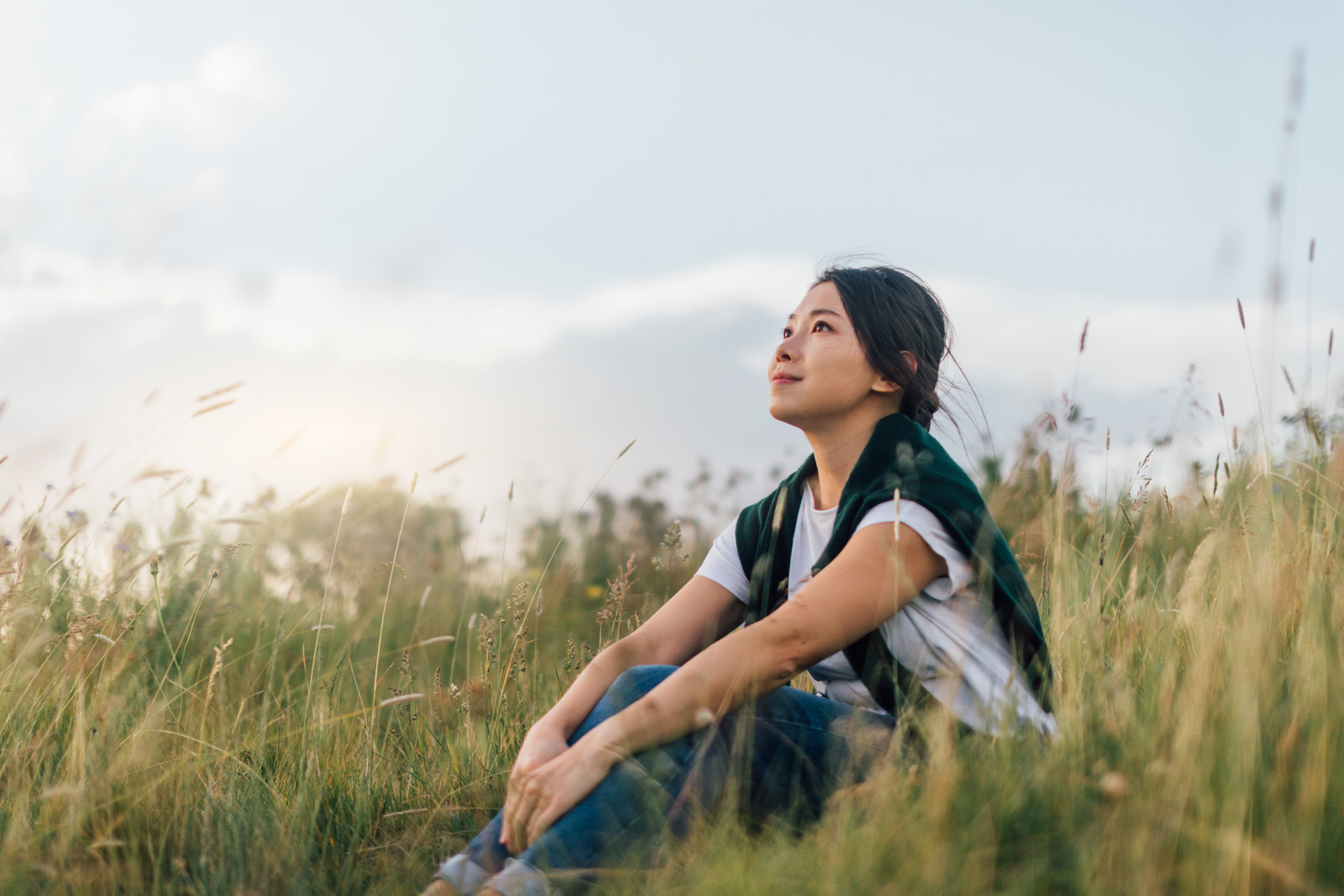 A woman sitting in tall grass