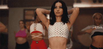 A high school cheerleader dancing.