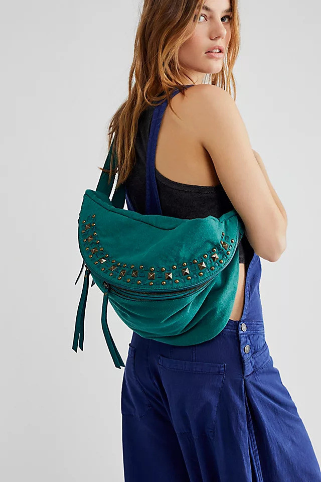 Model wearing the teal sling bag