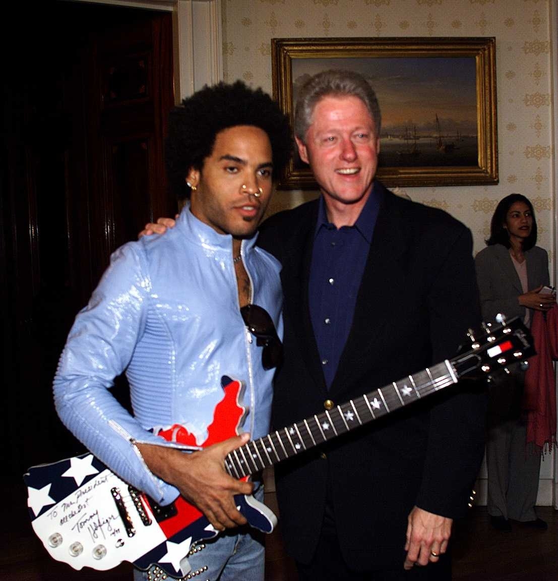 Lennie holding a guitar and standing with Bill Clinton