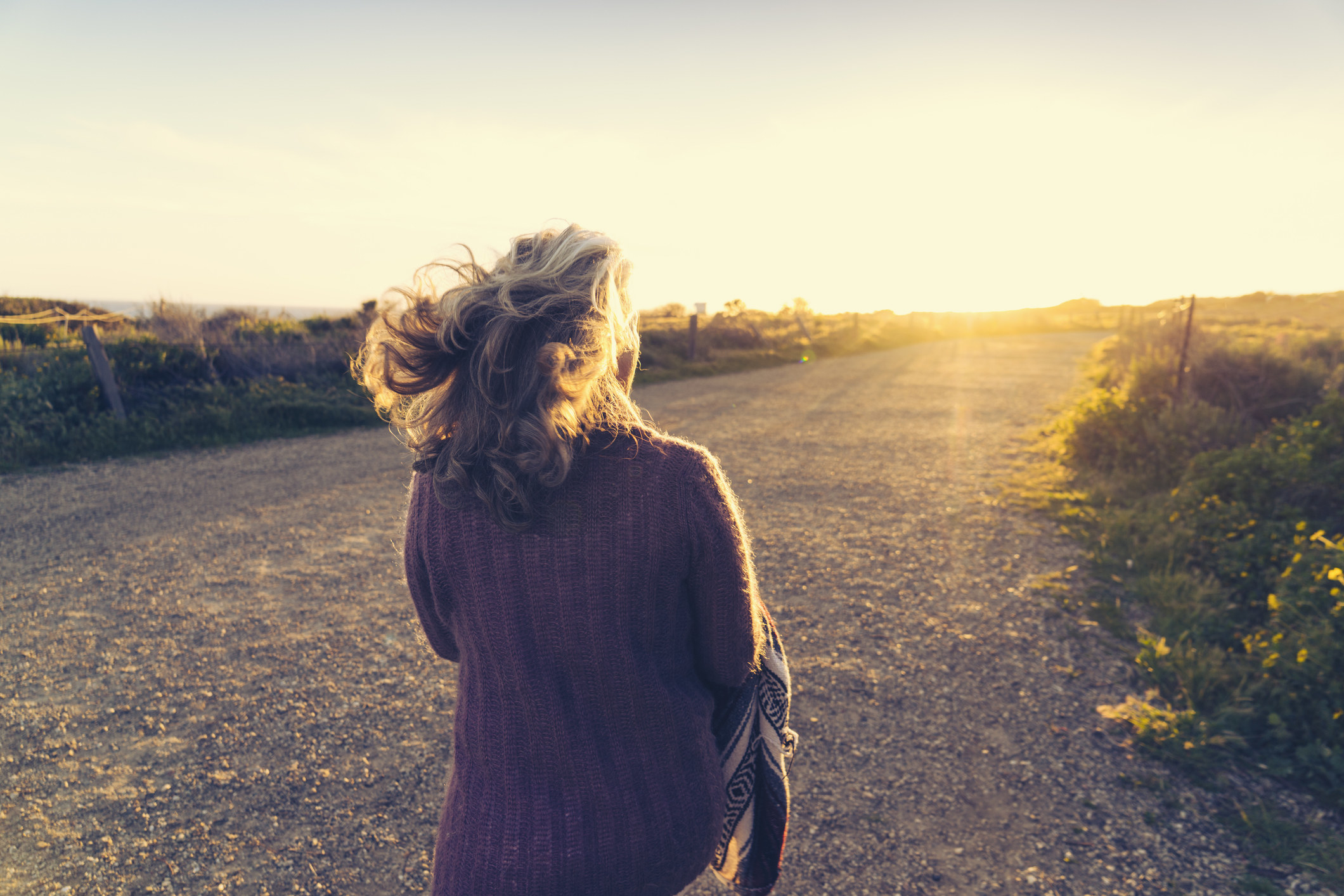 Woman walking along a country road