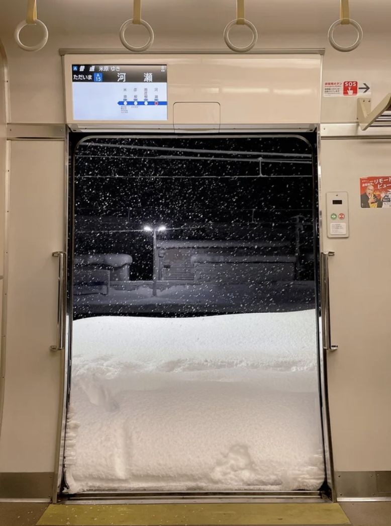 A train window half covered in snow