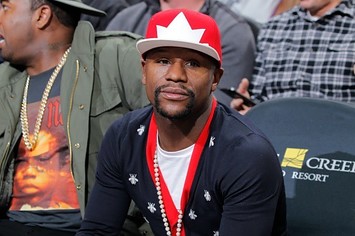 Floyd Mayweather attends an NBA game and sits courtside.