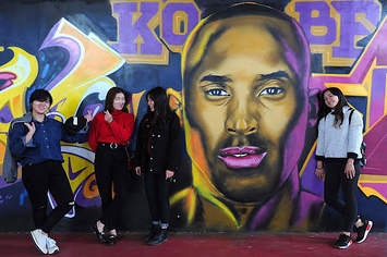 Kobe Bryant mural with young adults