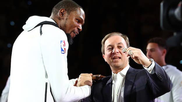 As Kevin Durant was collecting his ring before the Warriors' first game, Golden State's owner pantomimed him signing a new contract. KD just giggled.
