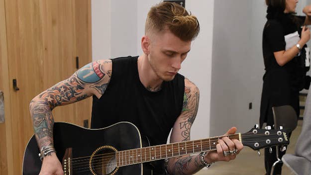 'The Dirt' star Machine Gun Kelly has put in at least a small amount of labor on a day some consider Labor Day. The source of his labor? Eminem's 'Kamikaze.'