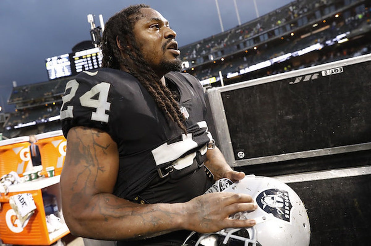 Marshawn Lynch sits during national anthem before NFL return