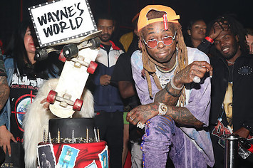 Lil Wayne stands next to his birthday cake.