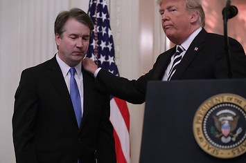 President Donald Trump puts his hand on Supreme Court Associate Justice Brett Kavanaugh's shoulder.