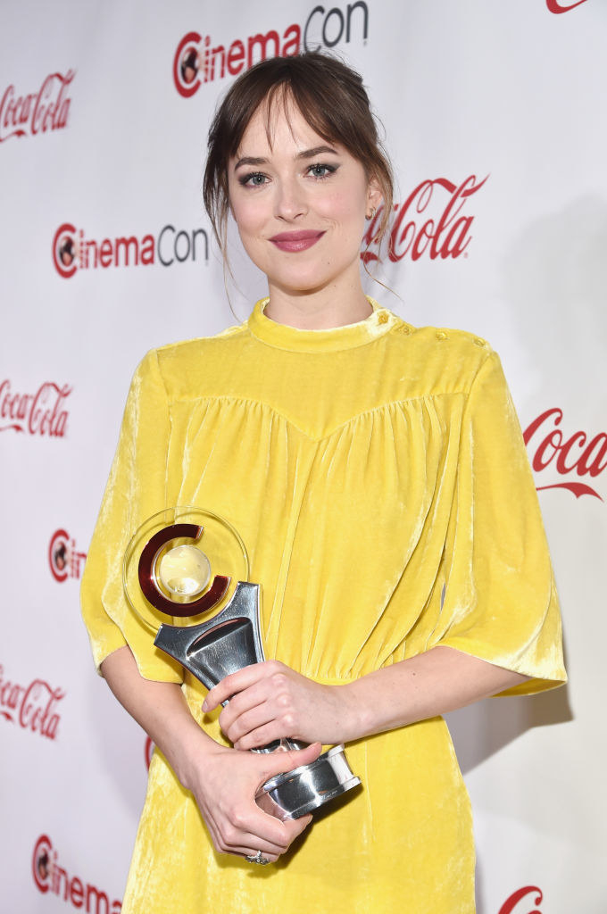 Dakota smiling and holding an award