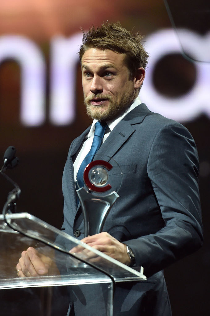 Charlie at a podium holding an award