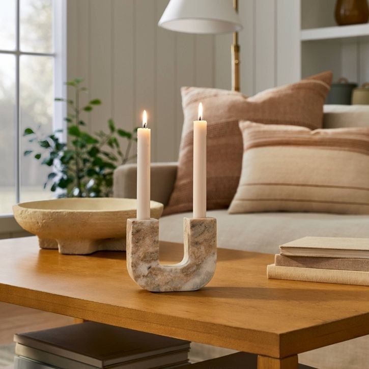 the marble candle holder on a coffee table