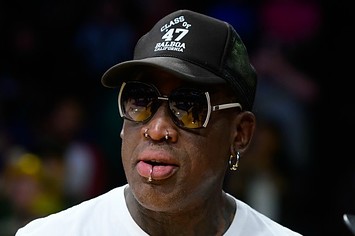 Dennis Rodman watches a Lakers game.