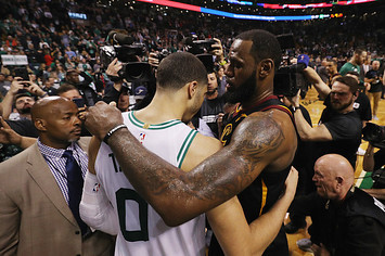LeBron James #23 of the Cleveland Cavaliers talks with Jayson Tatum #0 of the Boston Celtics.