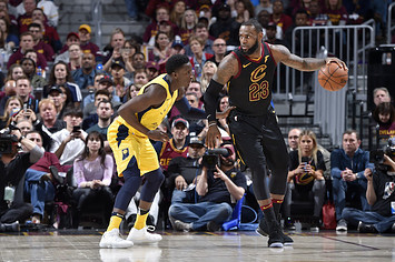 LeBron James #23 of the Cleveland Cavaliers handles the ball against Victor Oladipo.