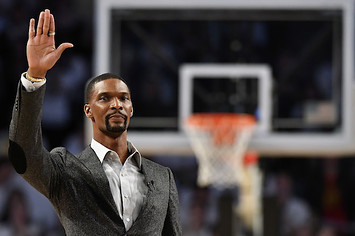 Chris Bosh waves to the crowd during a stoppage in play.