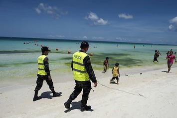 Police on the beach in the Philippines.