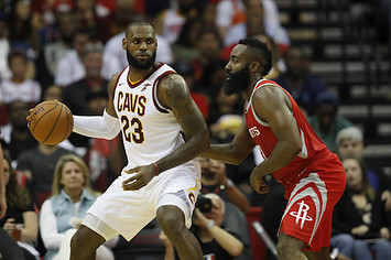 LeBron James #23 of the Cleveland Cavaliers controls the ball against James Harden.
