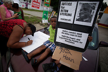 Demonstrators protest the fatal police shooting of Alton Sterling