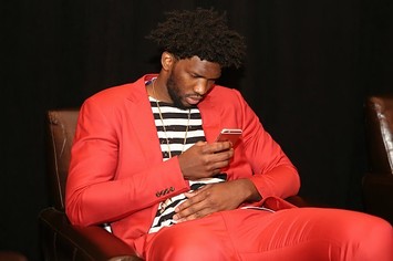 Joel Embiid checks his smartphone at the NBA Draft Lottery.