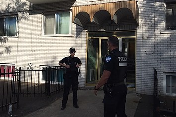 Montreal Police guard the front of the four storey building in Montreal