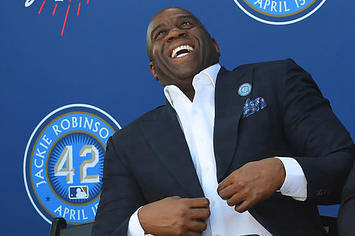 Magic Johnson laughs at a ceremony where the Dodgers unveiled a Jackie Robinson statue
