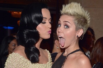Katy Perry (L) and Miley Cyrus arrive at the 55th Annual GRAMMY Awards