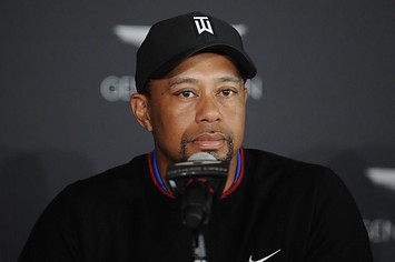Tiger Woods speaks with reporters.