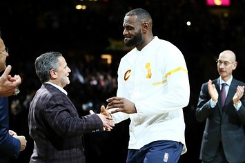 LeBron James and Dan Gilbert shake hands.