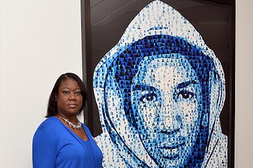 Activist Sybrina Fulton poses next to a collage of her son Trayvon Martin