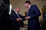 Donald Trump (C) shakes hands with James Comey