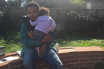 Chance the Rapper holds his daughter for an Instagram shot.