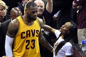 LeBron James passes by his mom Gloria during game.