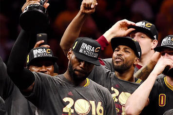 LeBron James holds up the trophy after winning the NBA Championship.