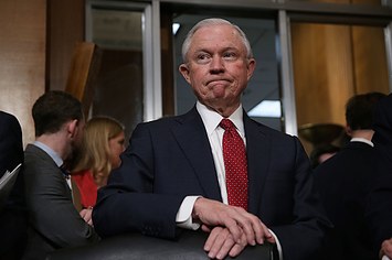 Jeff Sessions, a committee member, waits for the beginning of a meeting