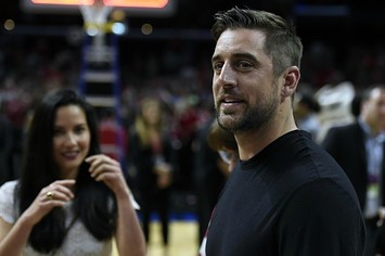 Aaron Rodgers and Olivia Munn at a basketball game.