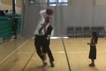 Youth basketball coach blocks his own player.