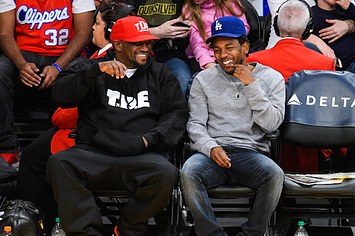 Anthony Tiffith (L) and Kendrick Lamar attend a basketball game