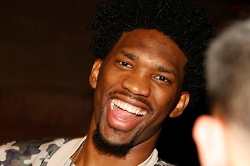 Joel Embiid laughs at an All Star party.