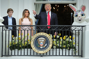 Donald Trump (C) delivers remarks from the Truman Balcony