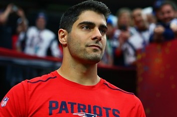 Jimmy Garoppolo stands on the sideline.