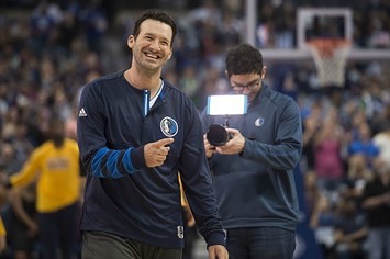 Tony Romo smiles in the Mavericks' layup line.