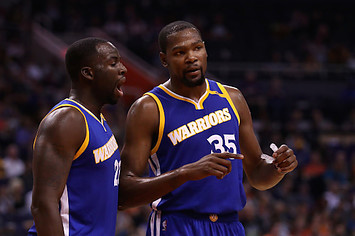 Kevin Durant #35 of the Golden State Warriors talks with Draymond Green #23